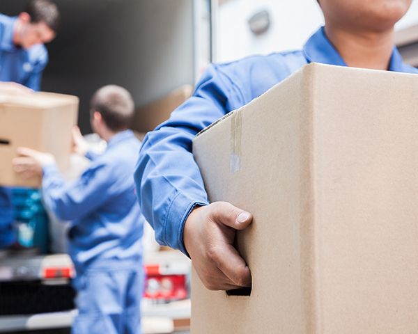moving workers unloading boxes from moving truck to take them to their client's house