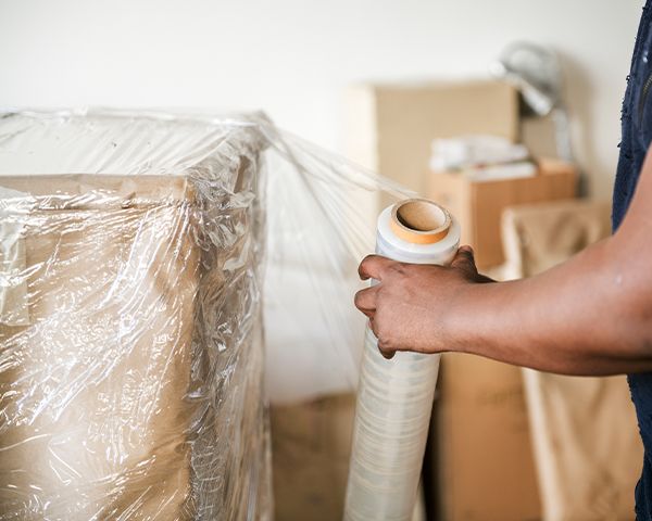 moving workers packing their client's belongings to transport them to their destination